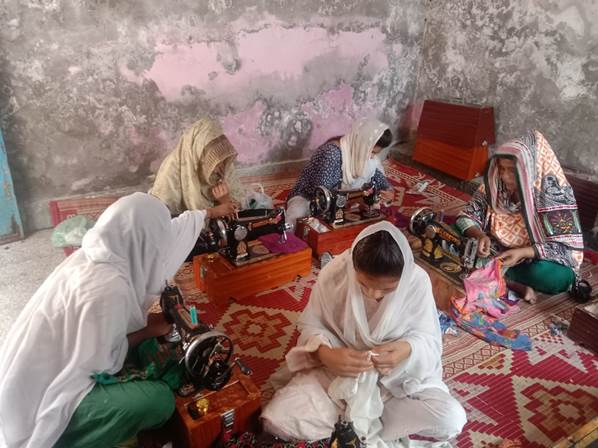 A group of women sewing on a rug

Description automatically generated with low confidence