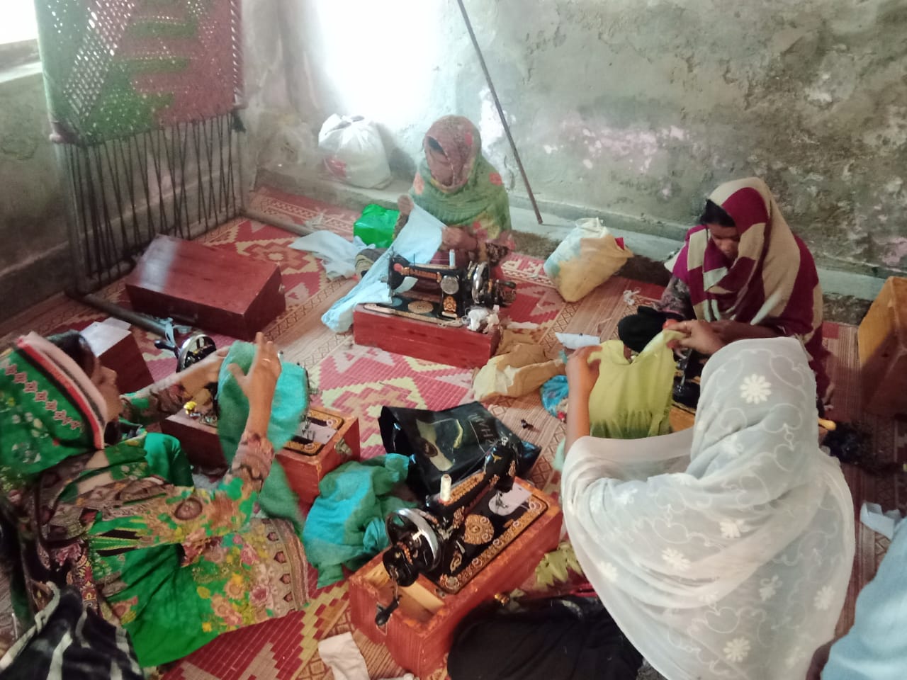 A group of women sitting on the floor

Description automatically generated