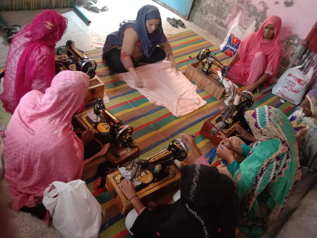 A group of women sitting on the floor

Description automatically generated with low confidence