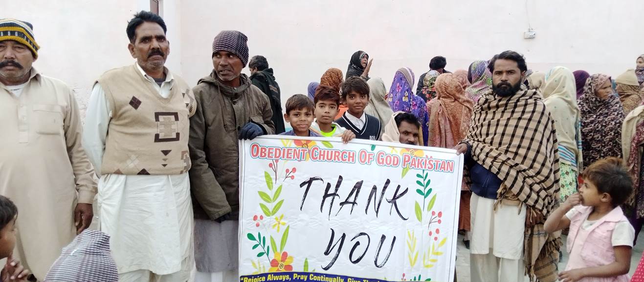 A group of people holding a sign

Description automatically generated